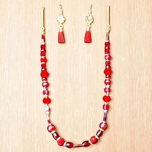 Red and gold tone necklace and earring set